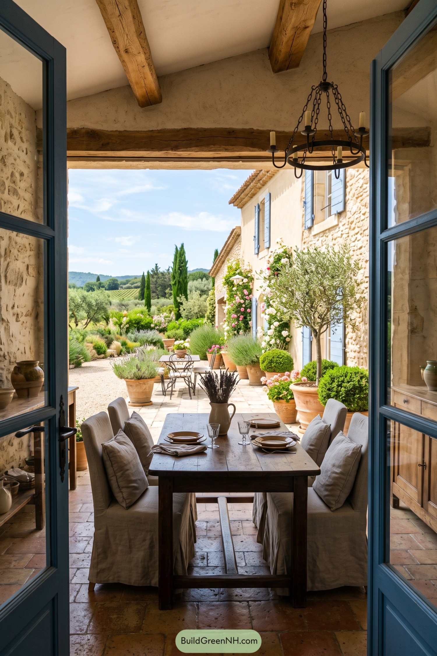 Rustic dining room opening onto a rose-filled Provençal courtyard