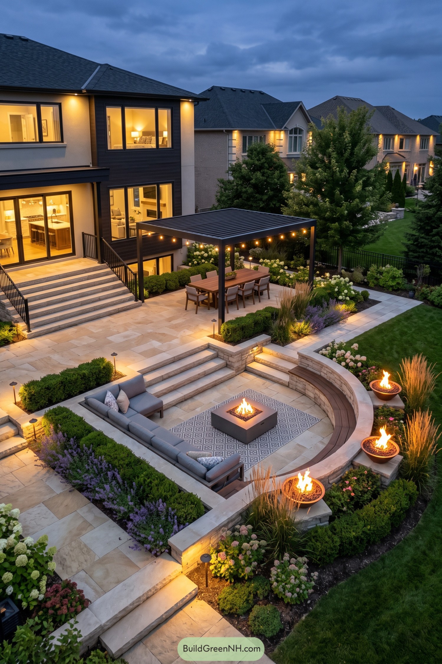 Tiered stone patio with a pergola dining area and curved fire lounge