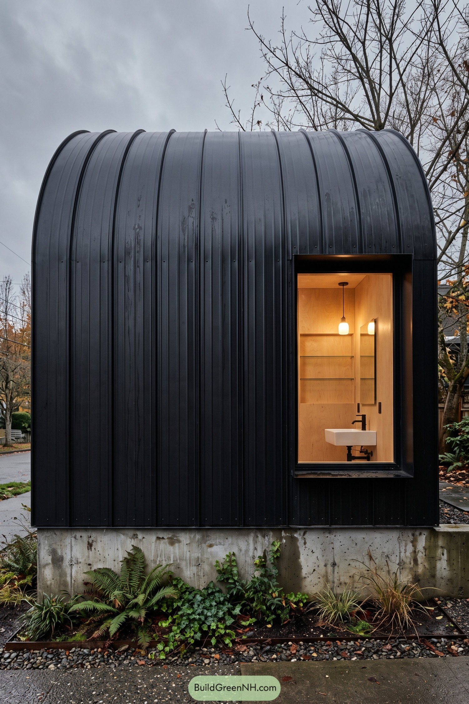 Black curved-roof pod with a glowing wood-lined washroom window