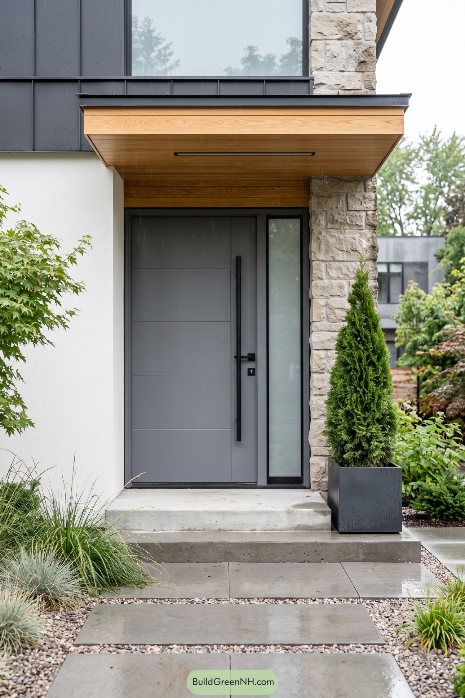Slate gray entry door with wood canopy and stone column