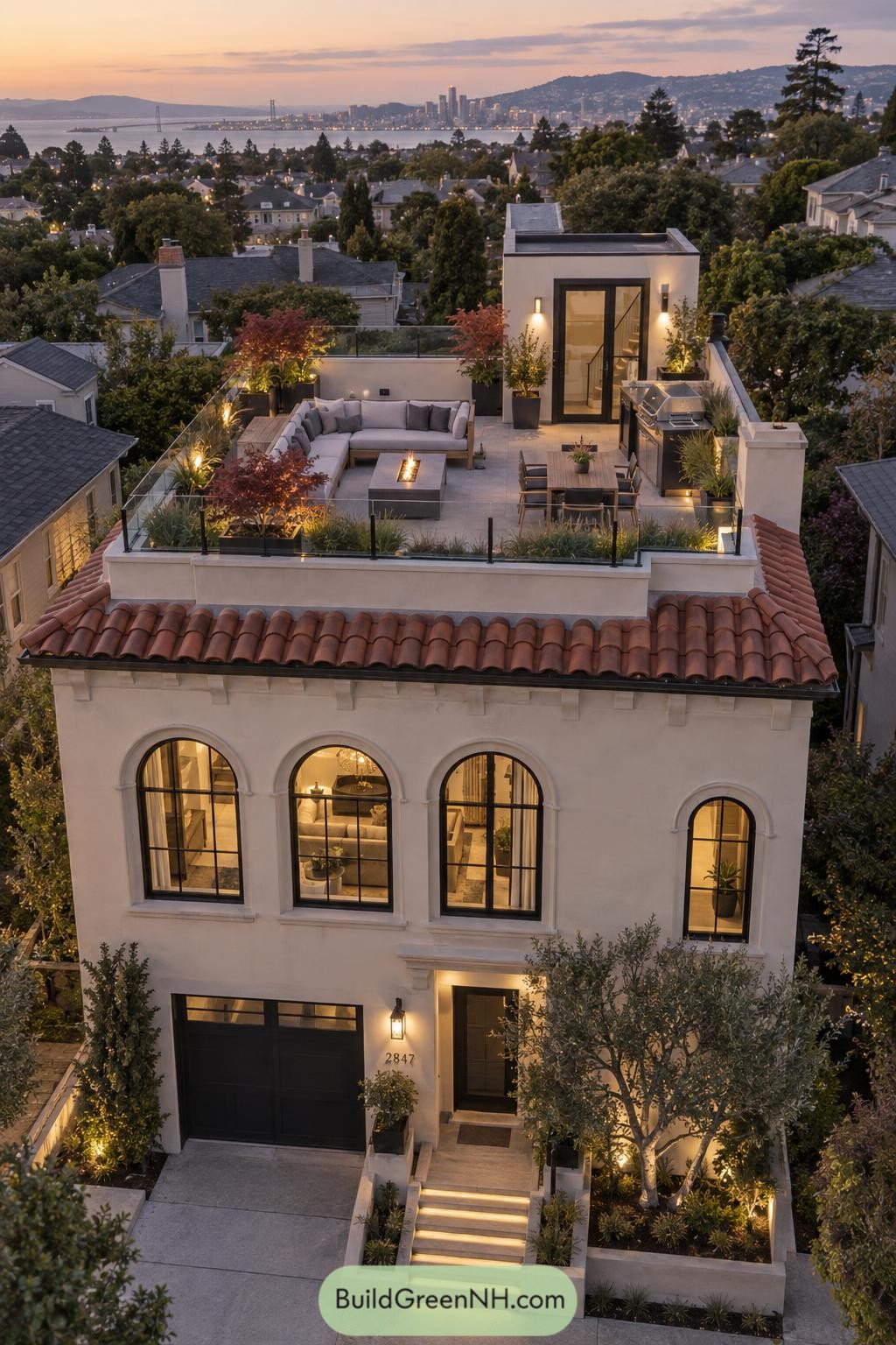 Twilight rooftop terrace with fire table and bay views