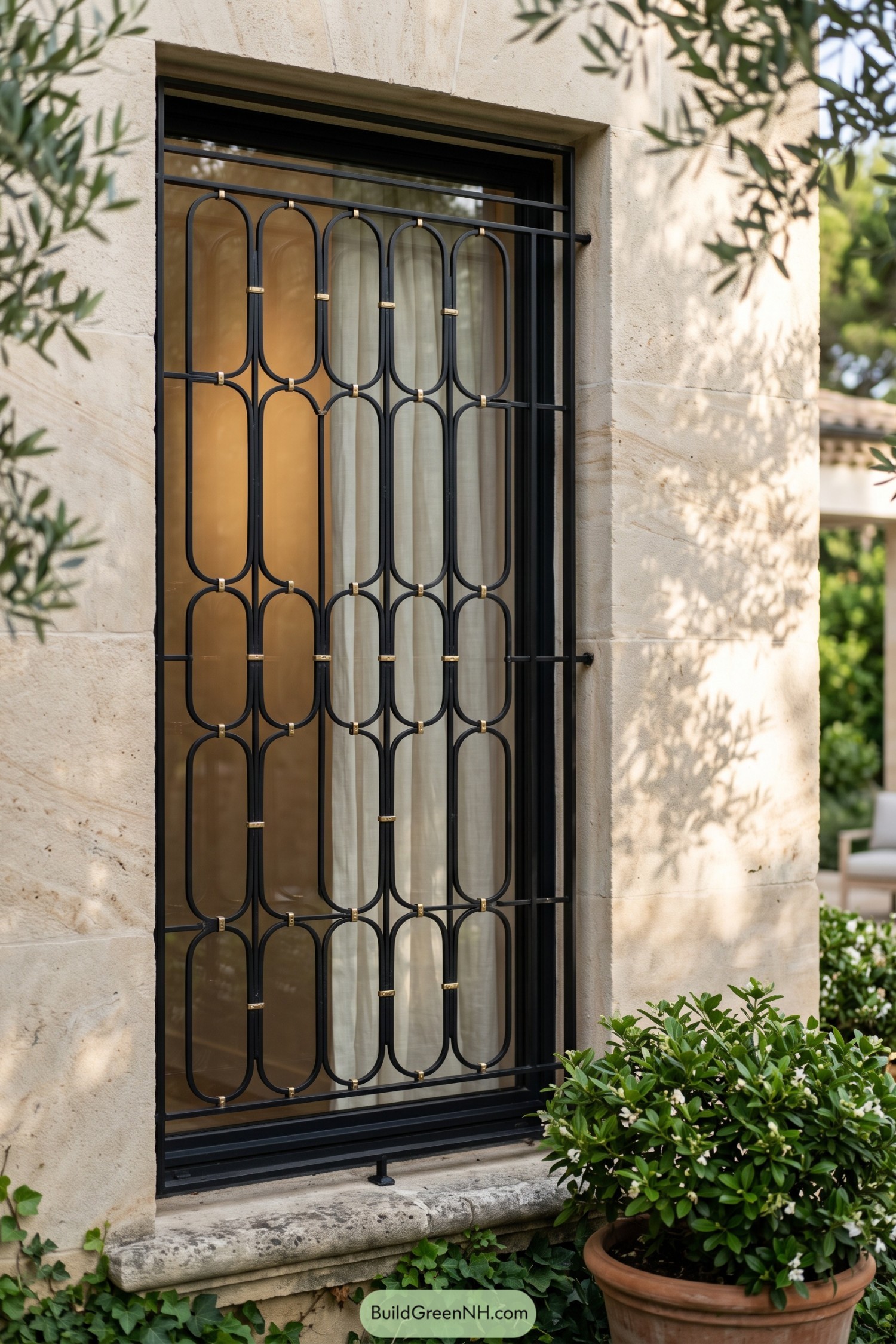 Black window grill with oval loops and brass accents