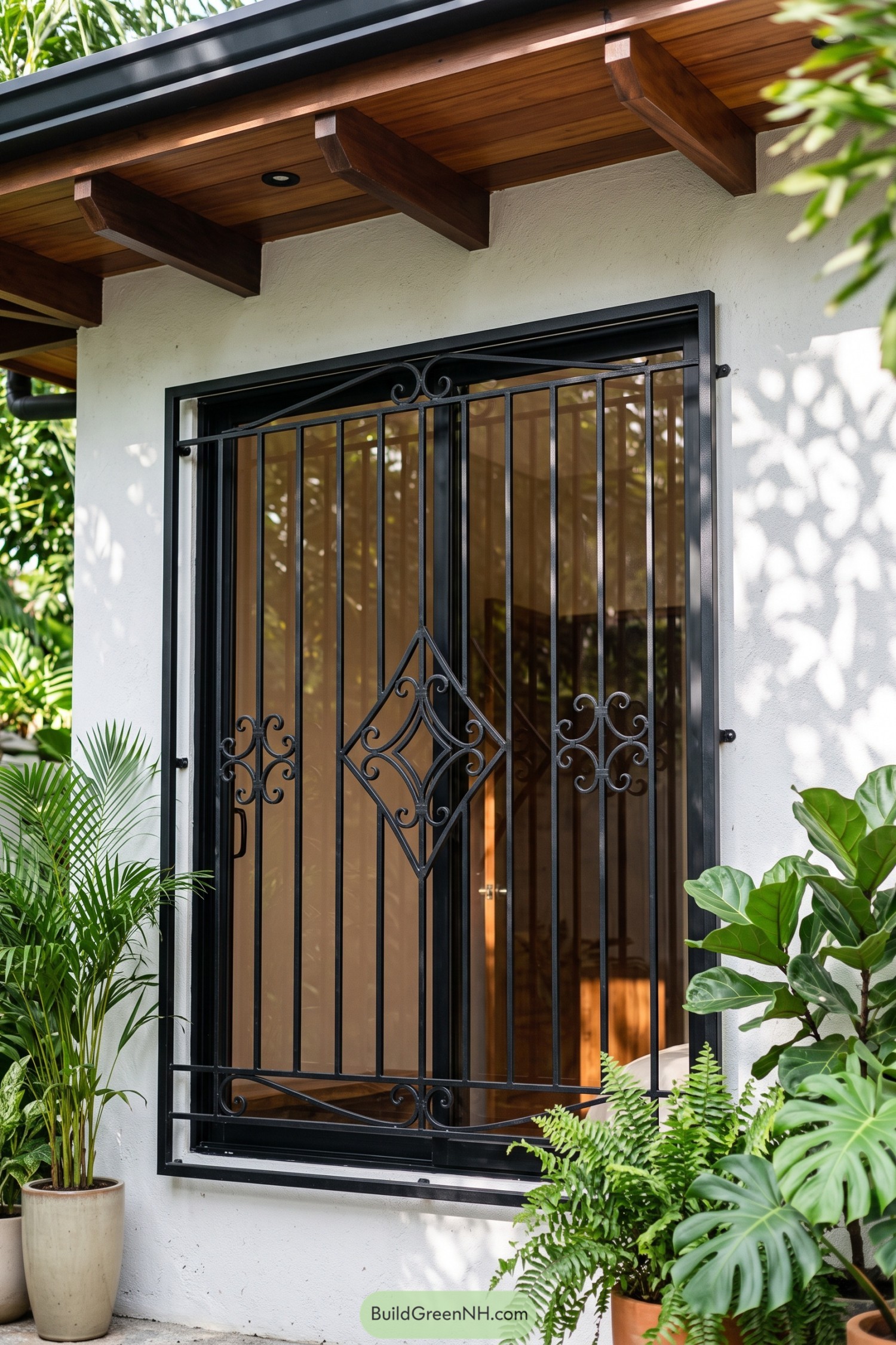 Black wrought iron window grill with diamond scrollwork centerpiece