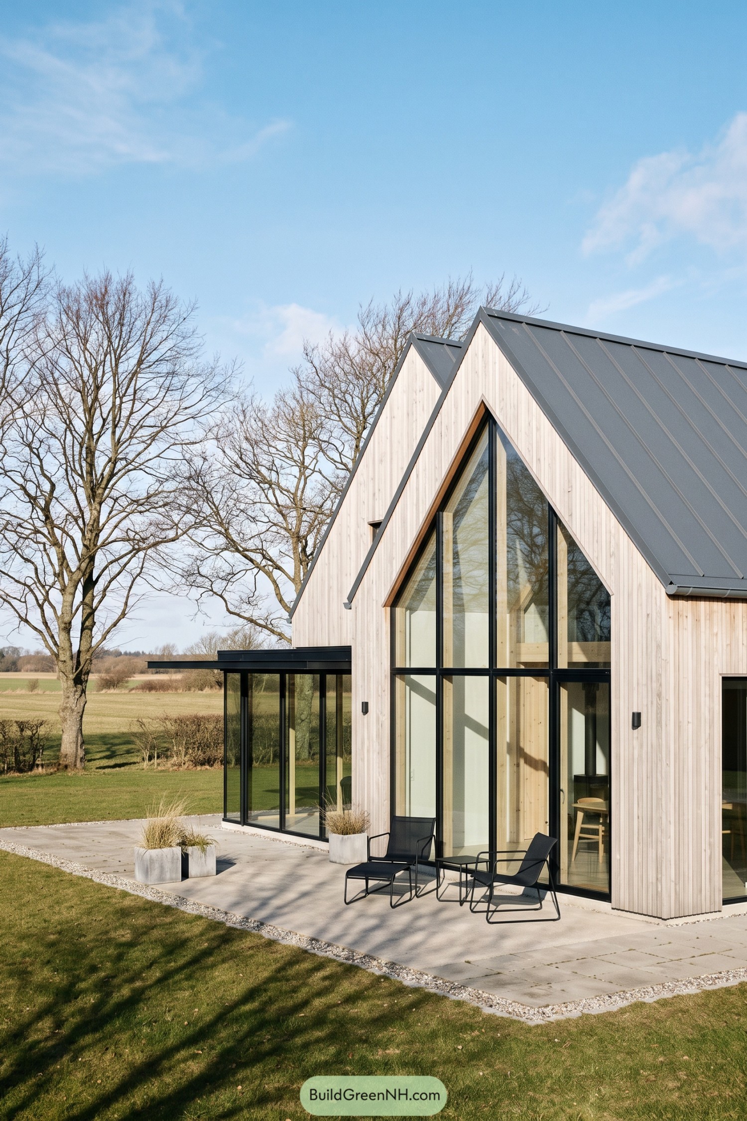 Pale timber twin gable house with glazed facade