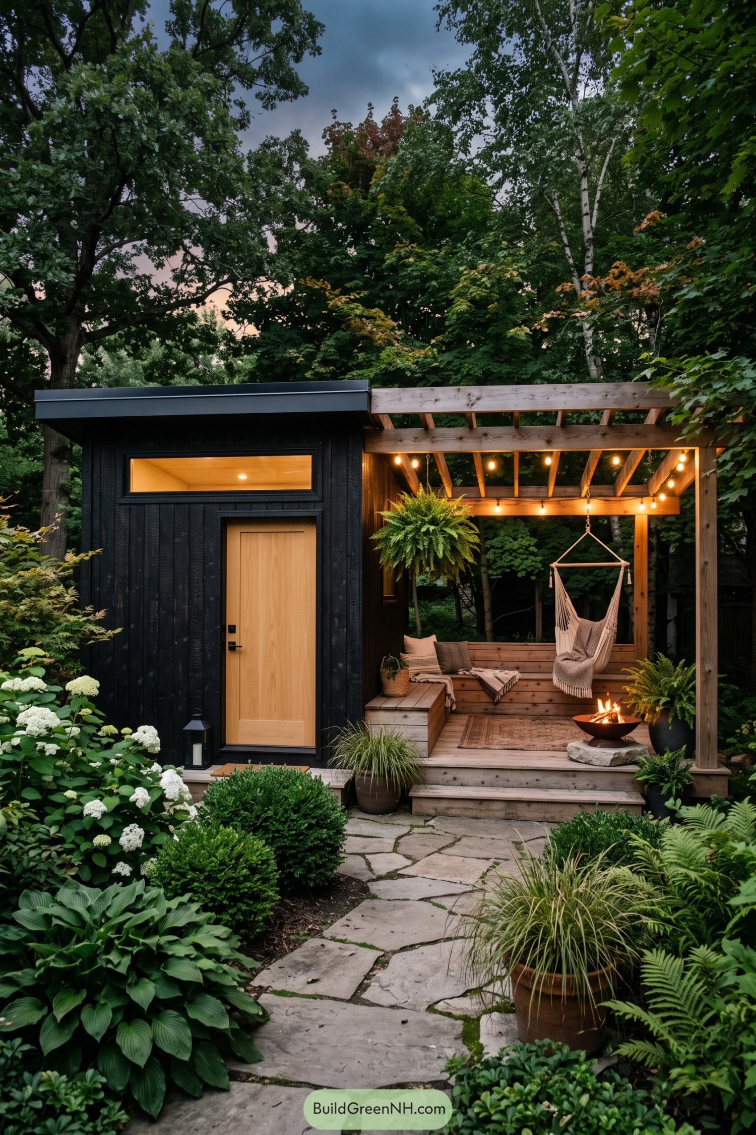 Black garden shed with a timber pergola porch hammock and fire bowl