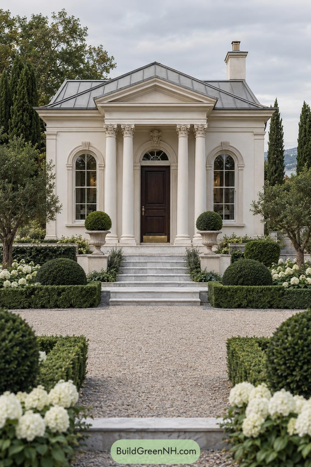Neoclassical white villa with columned portico and formal garden