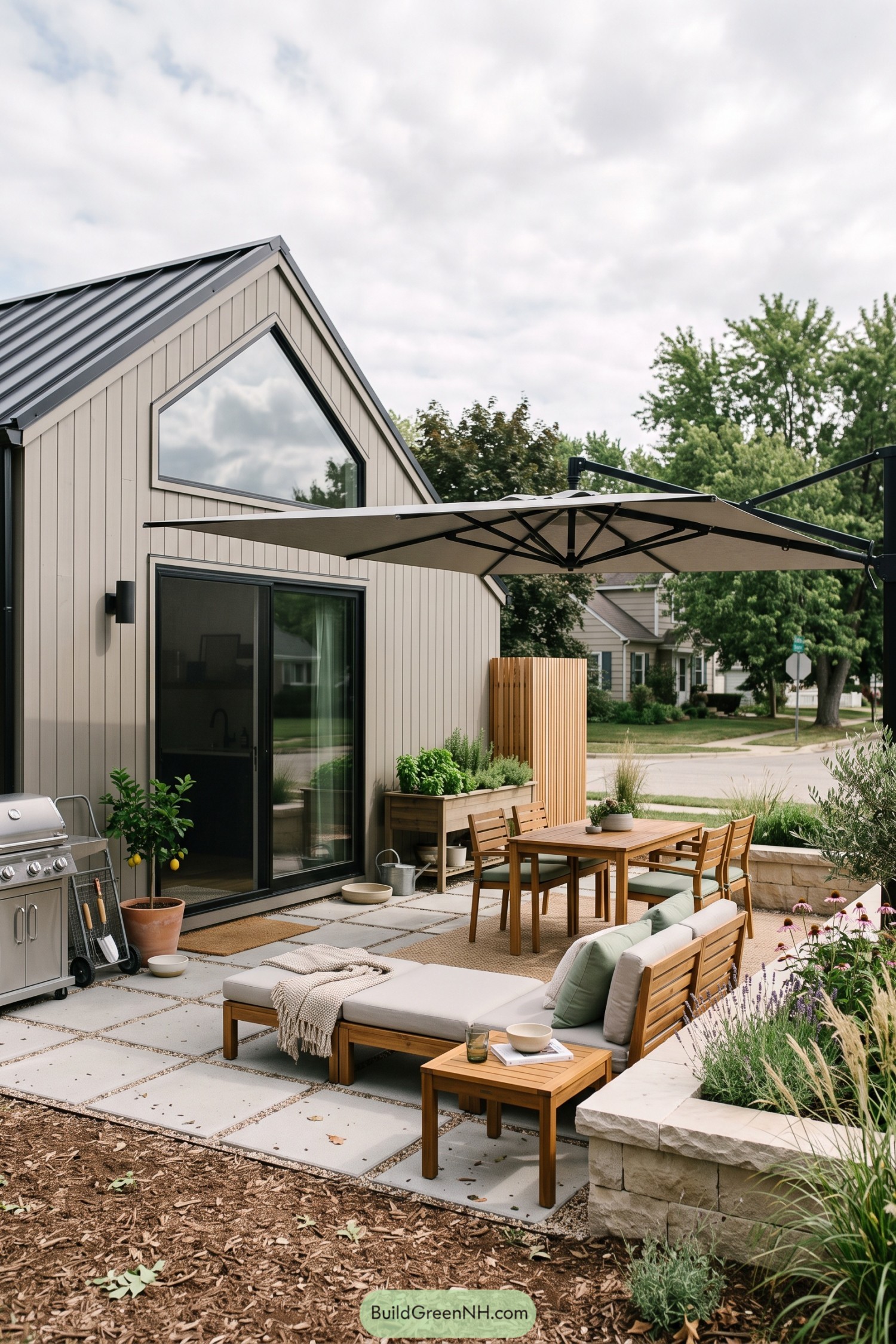 Modern barn house patio with umbrella and lounge seating