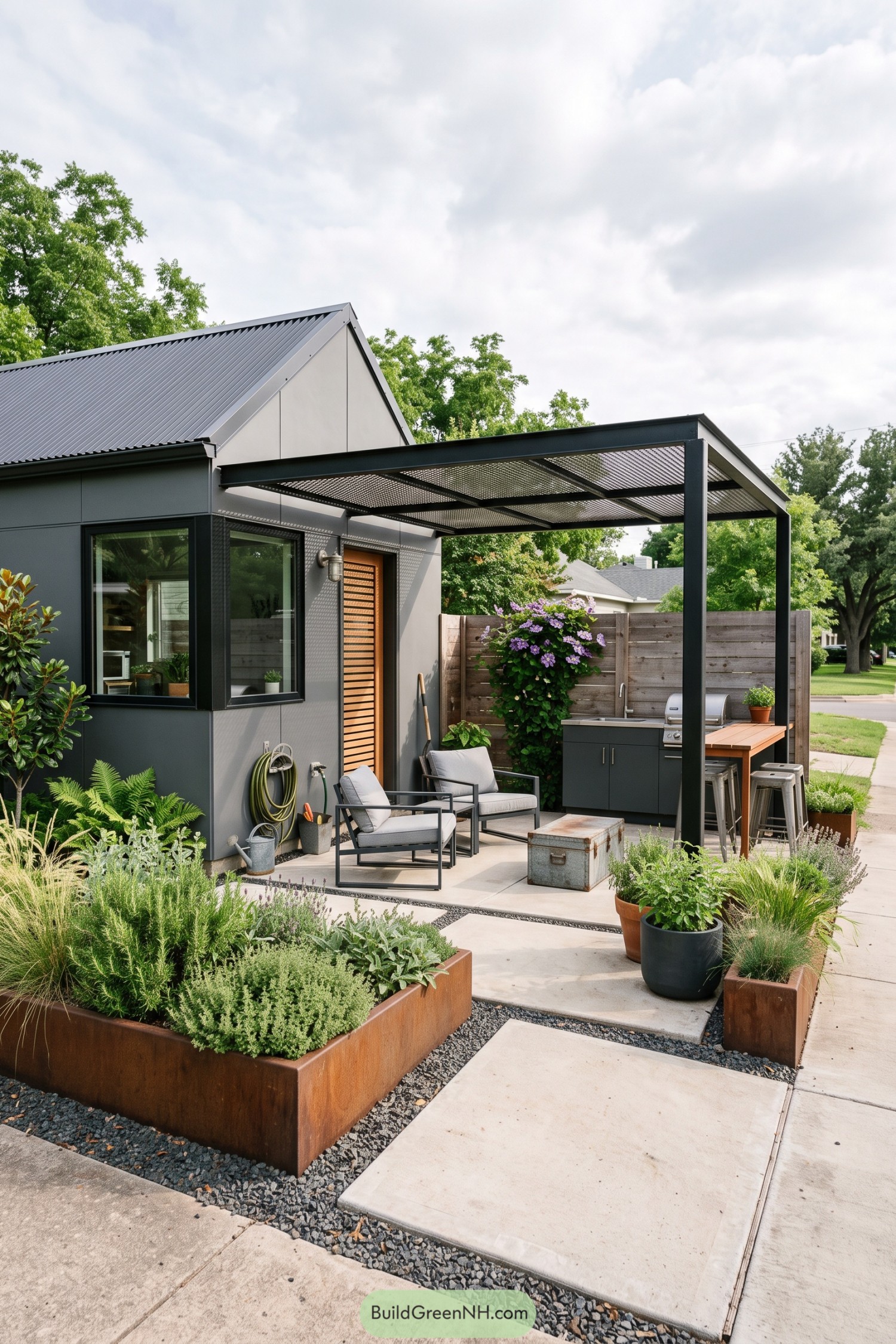Modern gray cottage with a covered outdoor kitchen and raised herb planters