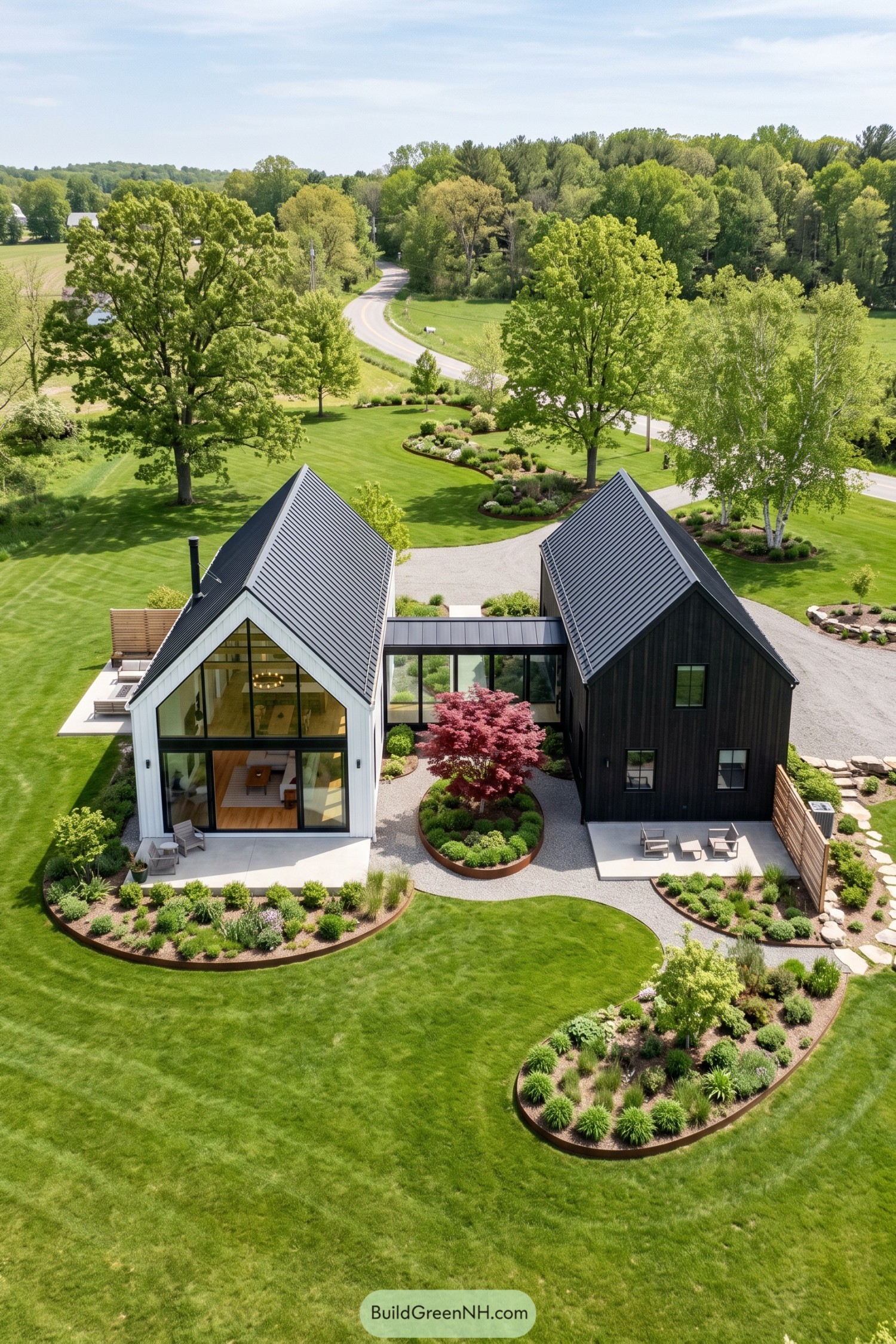 Twin gabled barns linked by glass amid landscaped lawns
