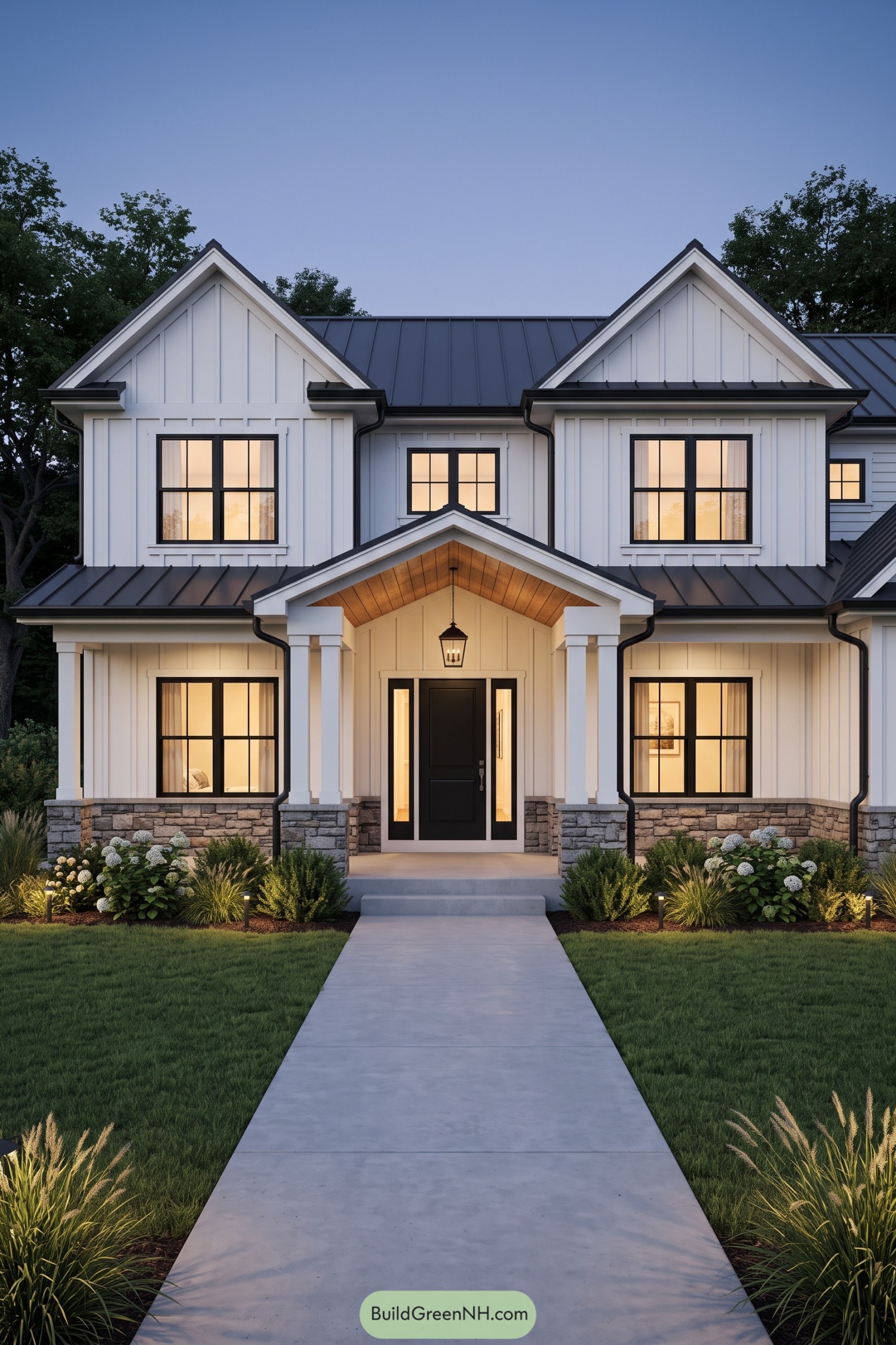 White farmhouse with twin gables black metal roof and stone porch base