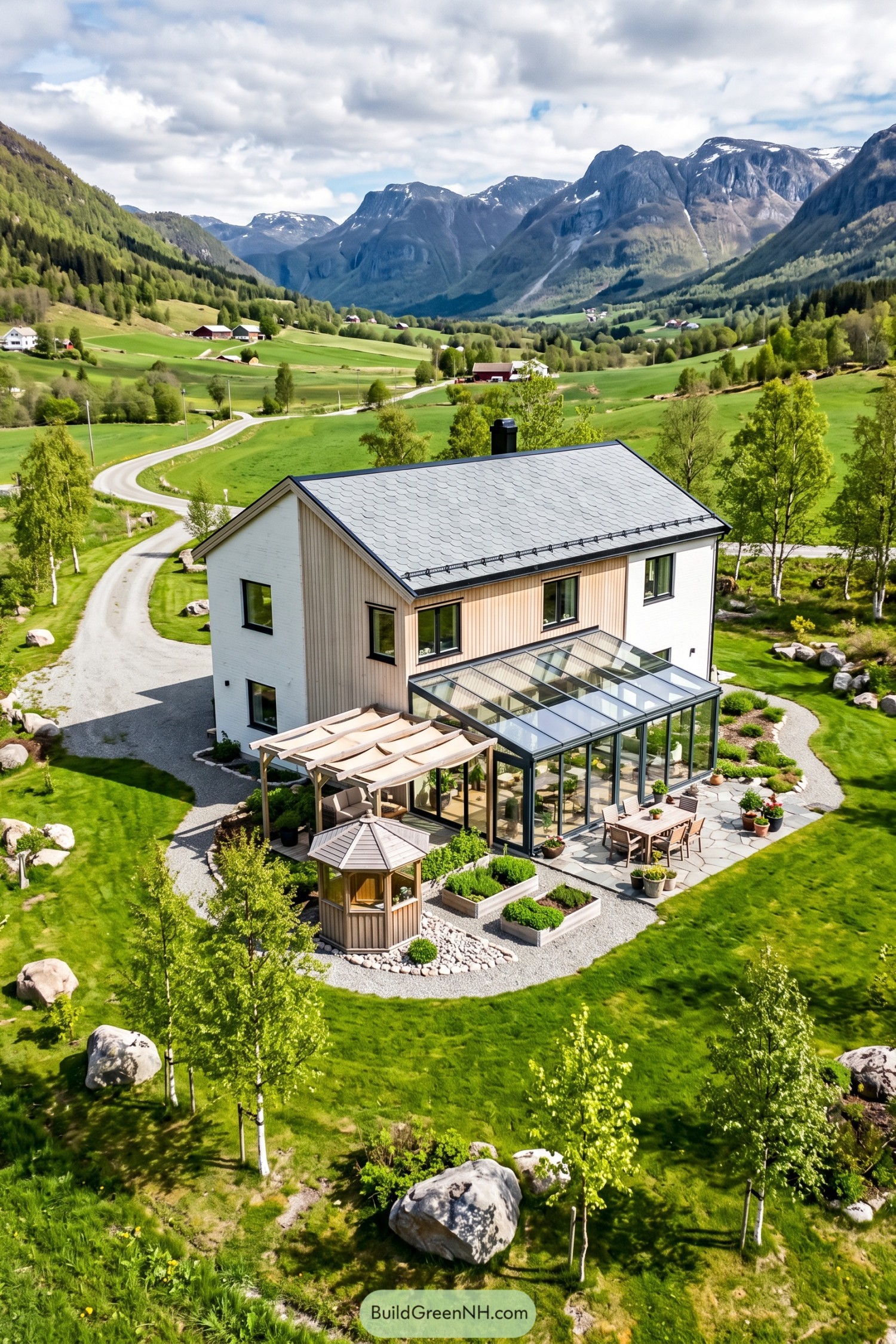 Two-story house with a glass conservatory, timber pergola, and stone dining terrace overlooking a mountain valley