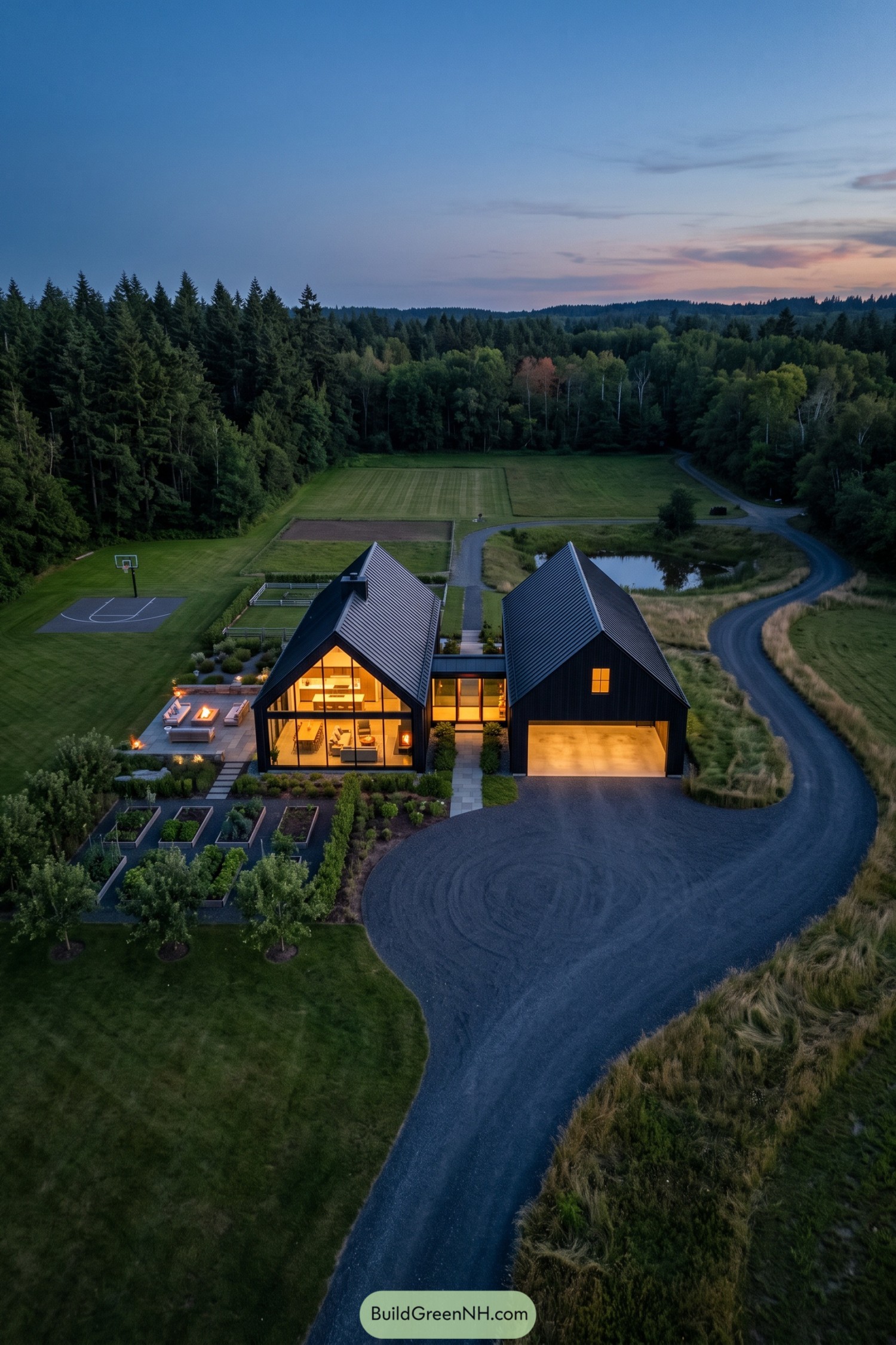 Aerial view of a black barn house with paired gables, a glazed living wing, garage, gardens, and a curving driveway