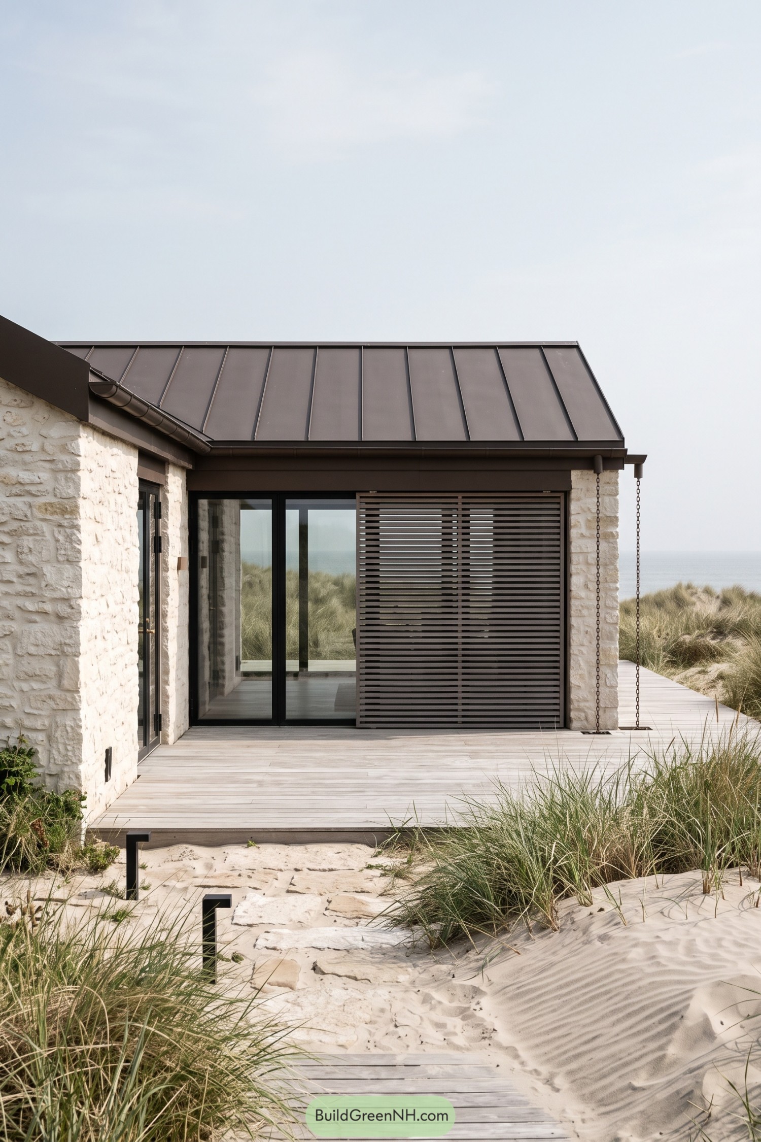 Stone retreat beside sandy dunes with a slatted timber screen