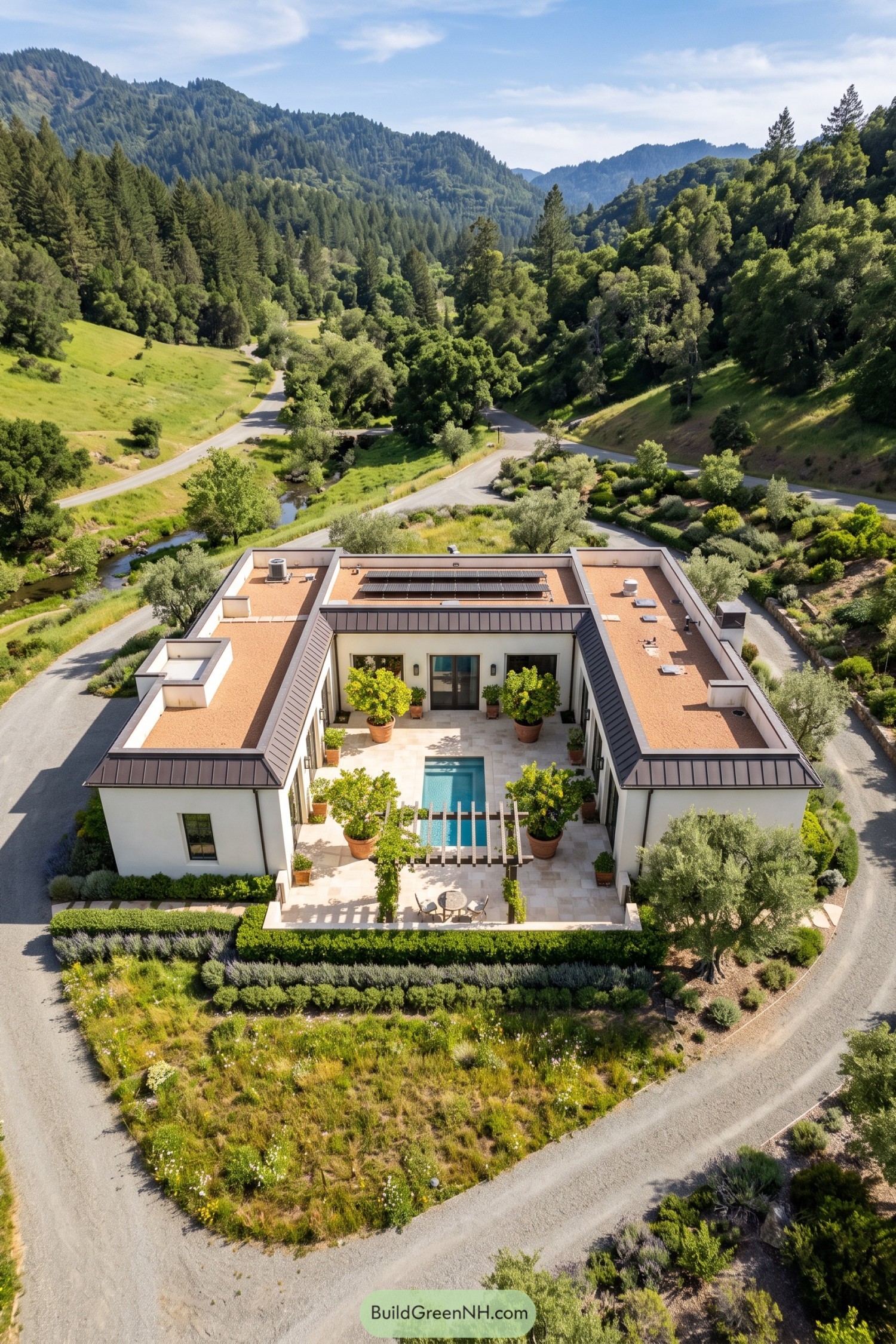 Aerial view of a courtyard villa with a narrow pool, potted citrus trees, a pergola, and rooftop solar panels